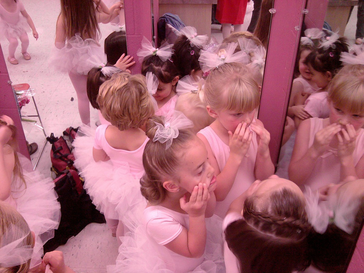 Ballet girls by the mirror preparing for the class